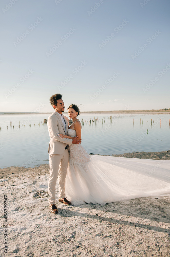 A beautiful romantic couple on an important day for them at sunset outside the city. Concept - love, romance, tenderness A beautiful romantic couple on an important day for them at sunset outside the city. Concept - love, romance, tenderness