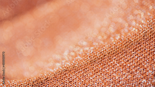 Detailed Macro Shot of an Orange Colored Piece of Cloth That is Wrinkled.
