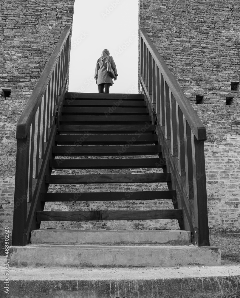 person walking on the wooden stairs