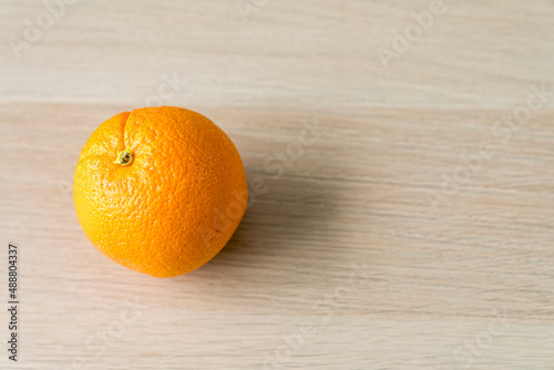 Orange on the wooden floor. Fresh Orange on the wooden table.