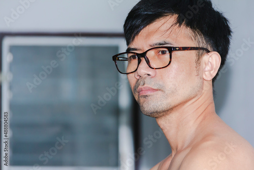 portrait asian man with glasses standing in the house during the day at home
