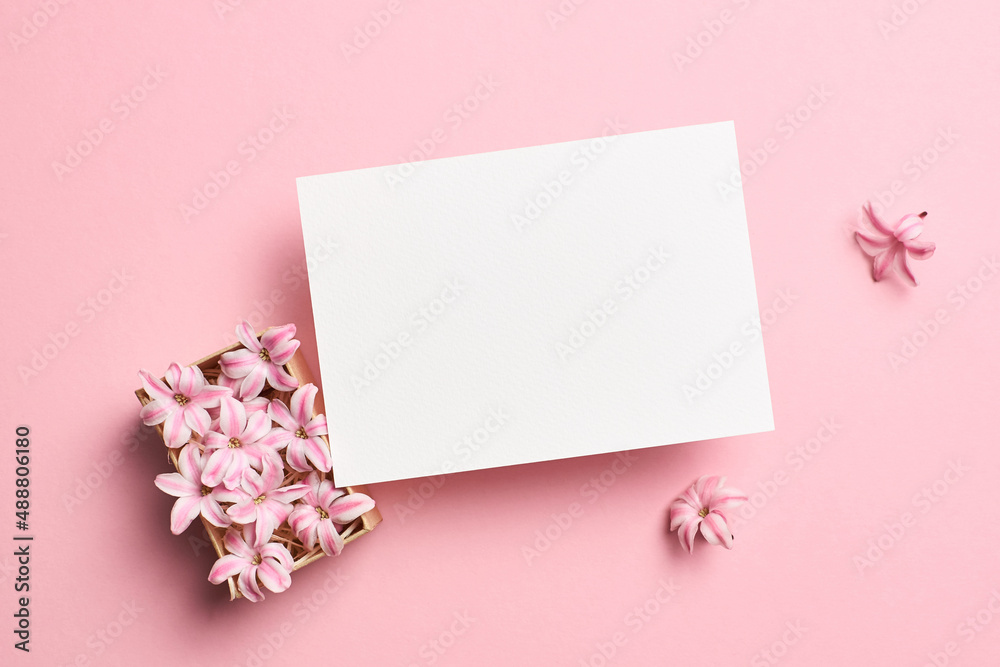 Invitation or blank greeting card mockup with hyacinth flowers on pink background Invitation or blank greeting card mockup with hyacinth flowers on pink background