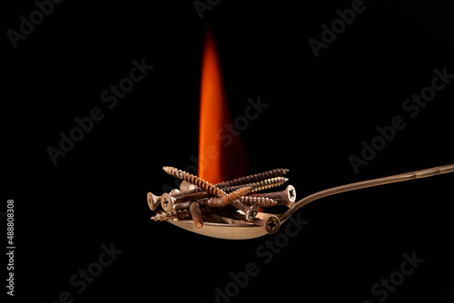 Screws on spoon with flame photo