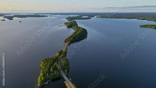 Aerial view of of islands on a blue lake Paijanne. Blue lake, islands and green forest from above on a sunny summer evening. Lake landscape in Finland