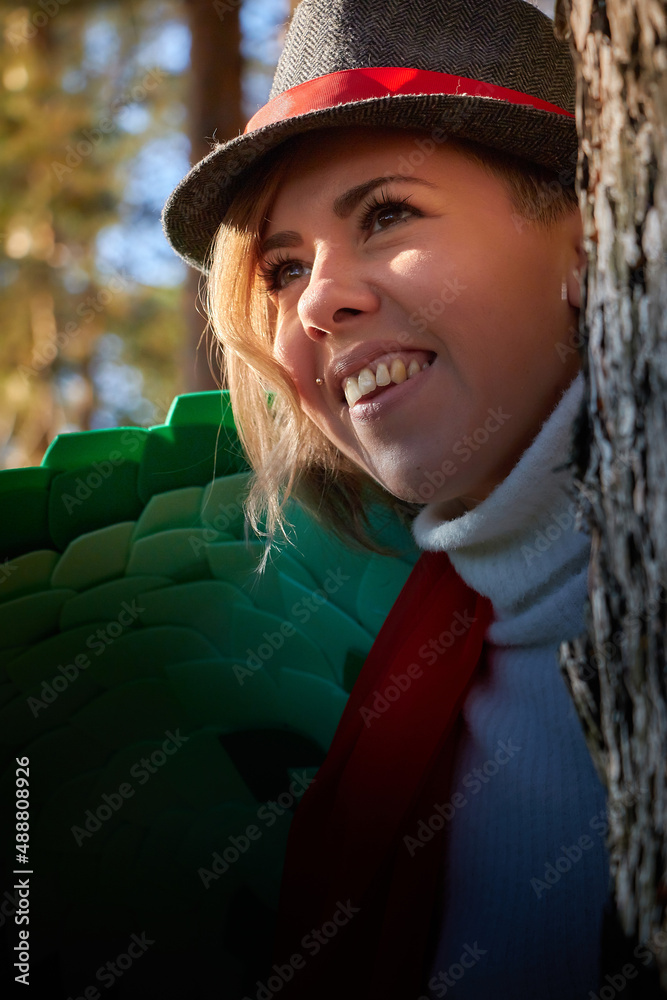 Portrait of young pretty funny smiling girl in male hat in sunny autumn day. Young happy woman having fun outdoor Portrait of young pretty funny smiling girl in male hat in sunny autumn day. Young happy woman having fun outdoor