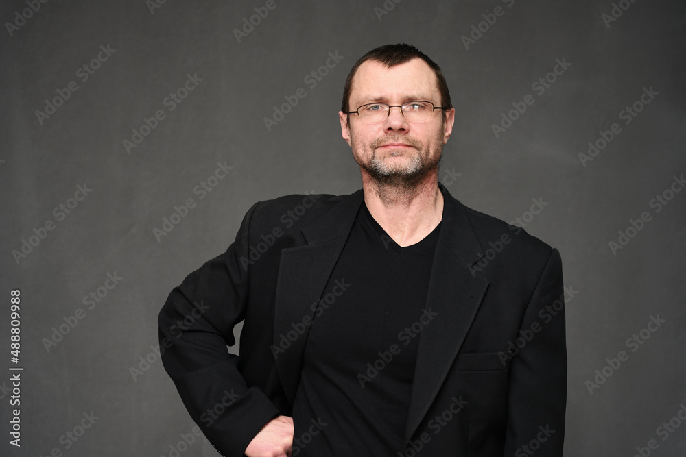 Portrait of a business man with a smile on a black background Portrait of a business man with a smile on a black background