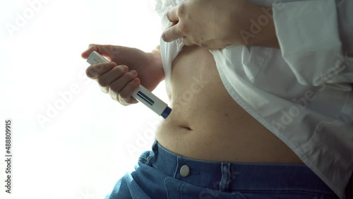 Woman doing Self-inject migraine pen medical treatment to prevent or reduce headache in adult