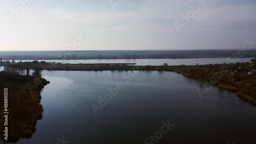 View of the river among the hills and villages. Aerial view 4K, 25 fps of the Yagorlyk River in the afternoon photo