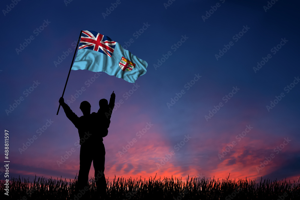 Father and son hold the flag of Fiji