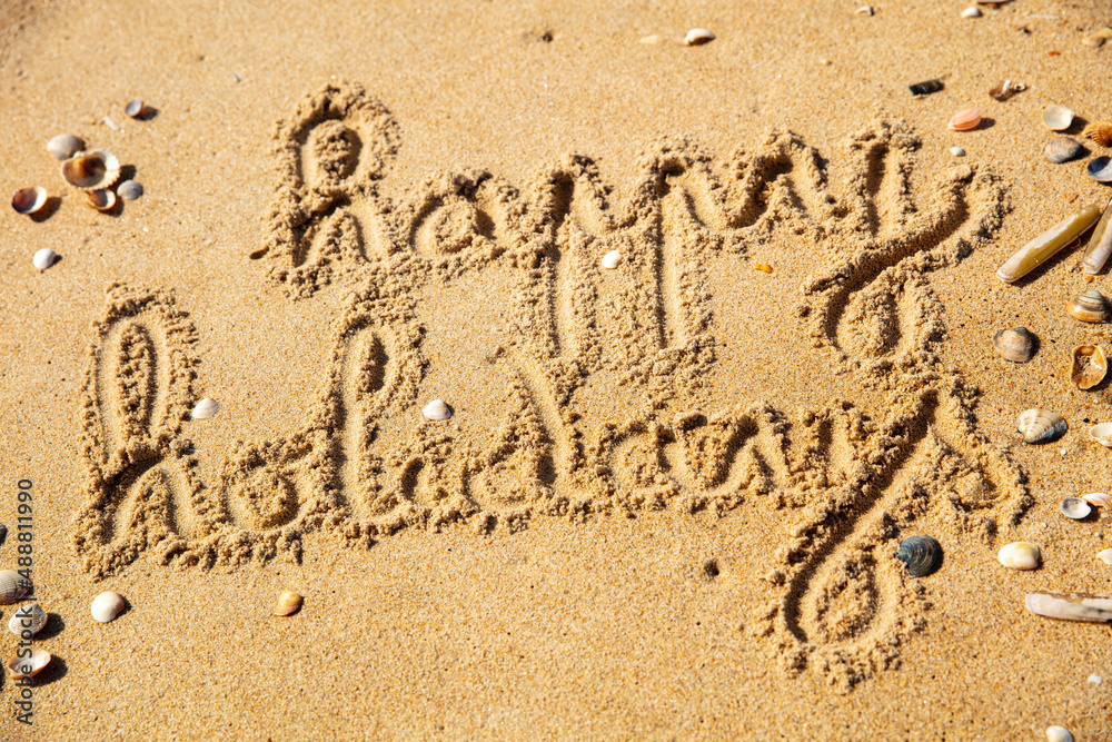 Fototapeta premium happy holidays writing on the beach