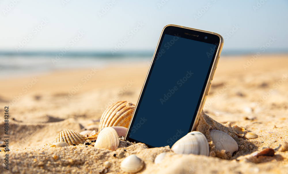 smartphone on the beach- holiday vacation concept - obrazy, fototapety, plakaty 