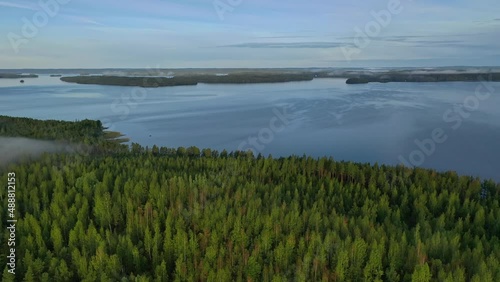Aerial view of Pulkkilanharju Ridge, Paijanne National Park, southern part of Lake Paijanne. Landscape with drone. Blue lakes, road and green forests from above on a sunny summer day in Finland.