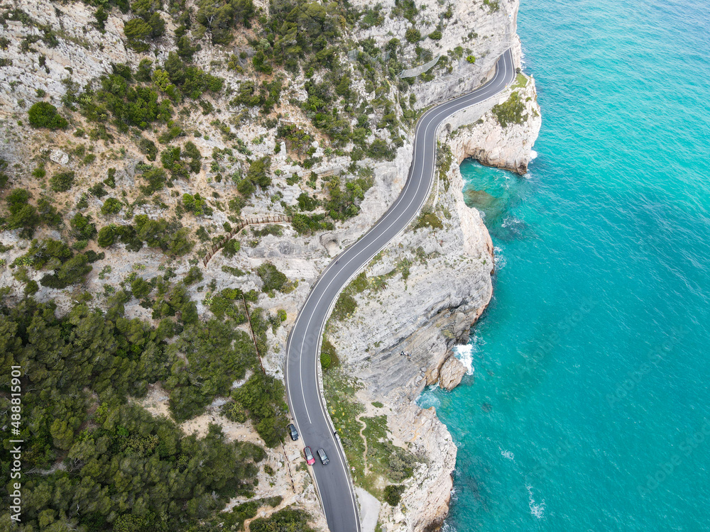 Aerial view of Aurelia street in Noli, Capo Noli and Varigotti, province of Savona. Drone photography from above of snake street snake in Liguria, north Italy, near Punta Crena and Spotorno.