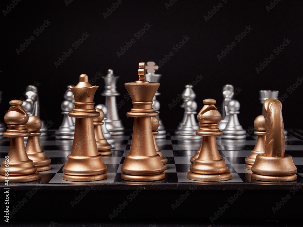 One chess piece stands against a full set of chess pieces. The concept of strategy, planning and decision-making One chess piece stands against a full set of chess pieces. The concept of strategy, planning and decision-making