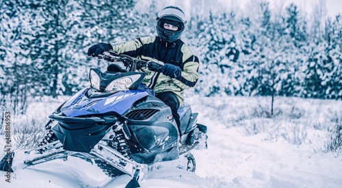 Εκτύπωση καμβά Man driving snowmobile in snowy forest