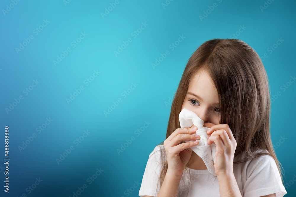 Young kid feels unwell, blows nose in tissue, suffers from running nose, cold symptoms or allergy Young kid feels unwell, blows nose in tissue, suffers from running nose, cold symptoms or allergy
