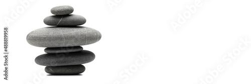 Pyramid of the balanced grey stones isolated on white background with copy space. Banner.