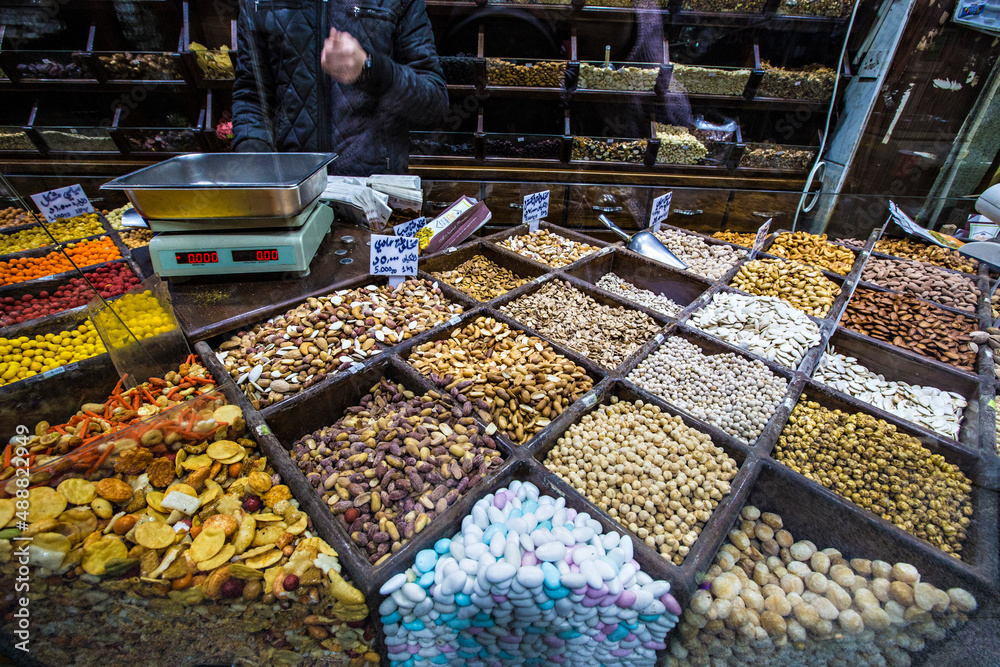 Naklejka premium Spices, nuts and sweets shop on the market in Amman downtown, Jordan. Choice of Arabic spices on the Middle East bazaar, Jordan
