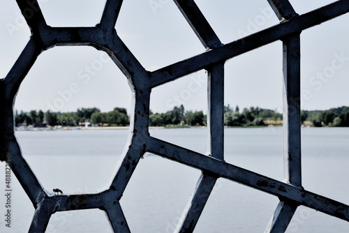 view of the lake through a metal spider web