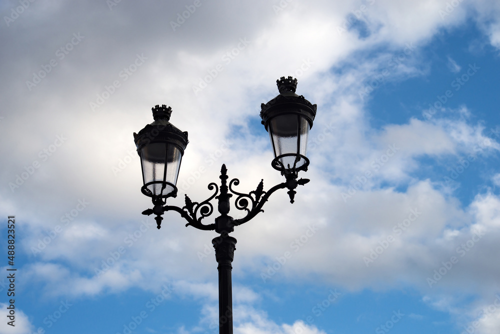 Closeup of vintage street light on beautiful cloudy sky background