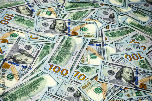 Cash money banknotes top view. US dollars wallpaper. American one hundred dollars. Heap of usd cash. Concept of finance and money 