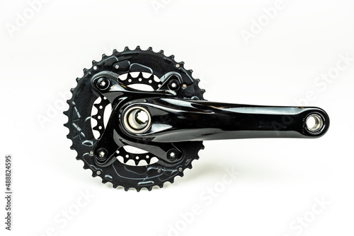 black chainring and crank on white background. bicycle gear