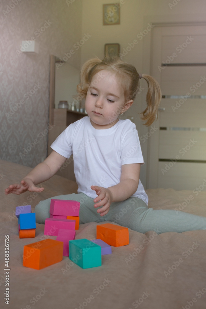 little girl plays with a soft children's constructor little girl plays with a soft children's constructor