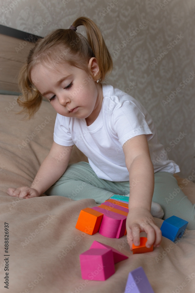 little girl plays with a soft children's constructor little girl plays with a soft children's constructor
