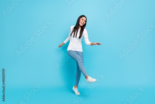 Full length photo of young woman have fun dance chill free-time casual outfit isolated over blue color background