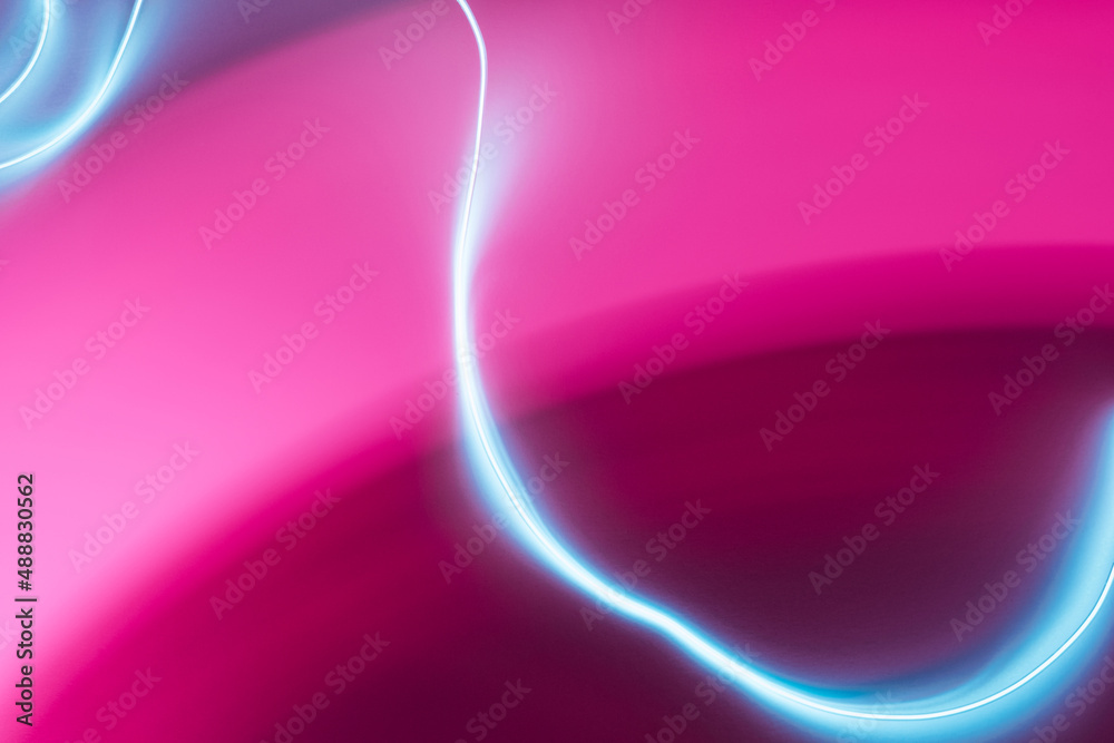 Naklejka premium Neon abstract led lines on a magenta background. Fluorescent cyberpunk backdrop.