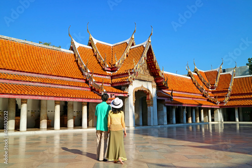 Couple Admiring the Amazing Cloister or Phra Rabiang of Wat Benchamabophit (The Marble Temple), a Significant Landmark in Bangkok, Thailand photo