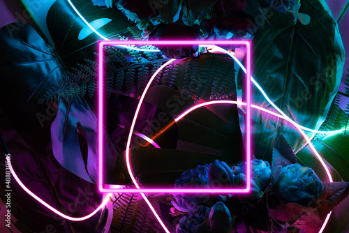 Fototapeta Naklejka Na Ścianę i Meble -  Neon square frame on a dark floral jungle background. Artificial reality conceptual template.