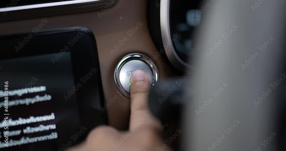 Close up of Man presses start button in car motor. Turning on functioning systems vehicle. Start using car before driving, start electronic systems in car. Close up of Man presses start button in car motor. Turning on functioning systems vehicle. Start using car before driving, start electronic systems in car.