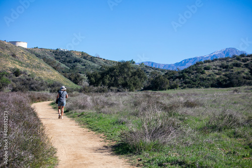 A Beautiful, Healthy and Mature Woman Hiking on a California Chaparral Trail 