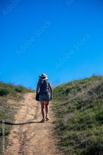 A Beautiful, Healthy and Mature Woman Hiking on a California Chaparral Trail 
