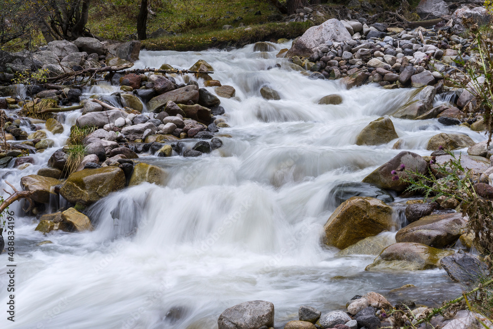 Mountain waterfall in the forest. Waterfall view. Waterfall in mountains. Waterfall pool