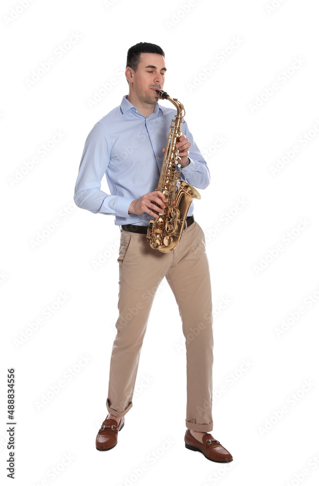 Naklejka premium Young man playing saxophone on white background