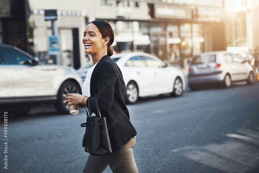 Off to meet a client around town. Shot of a young businesswoman walking in the city. Off to meet a client around town. Shot of a young businesswoman walking in the city.