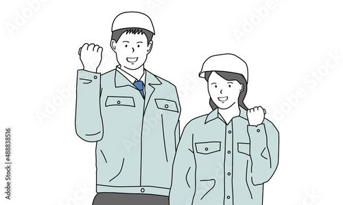 ガッツポーズをする男女の作業員