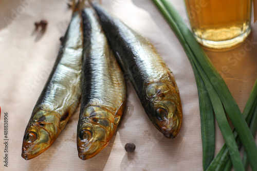 smoked herring with beer on a table