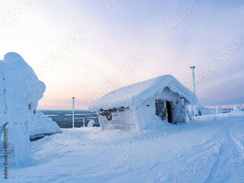View of a snow covered wooden building in Ruka Ski Resort, Kuusamo, Finland photo