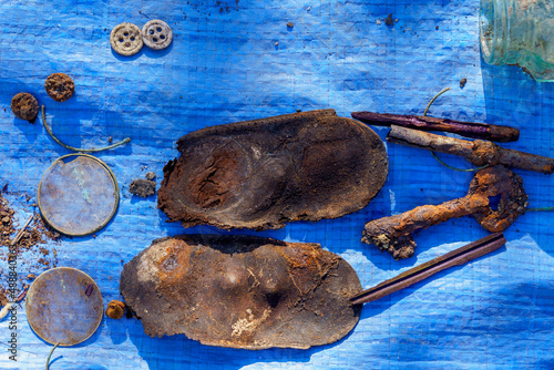 Retro leather insoles on blue burlap. Archaeological excavations of criminologists for examination. Background photo