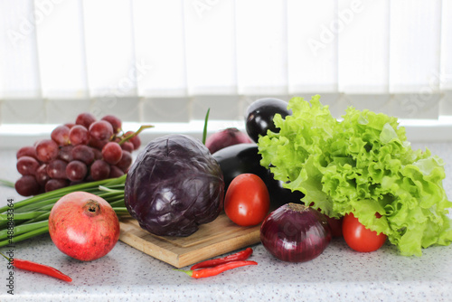 fresh vegetables and fruit on a wooden board