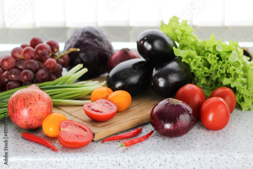 fresh vegetables and fruits on a cutting board