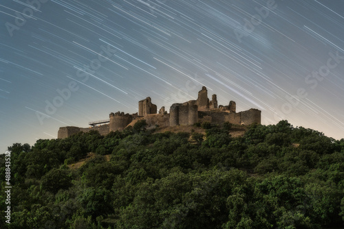 Old castle on top of hill at night time photo