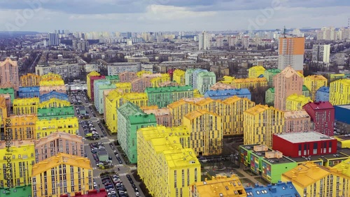 Fly over multi-colored residential buildings in Kiev in cloudy weather. Aerial drone flight.