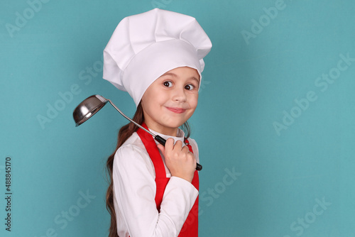 chef girl with ladle isolated on blue background