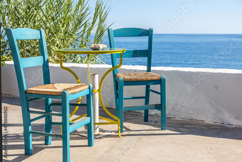 Outdoor seaside cafe  coffee and drink bar empty table and chair  summer sunny day. Greece