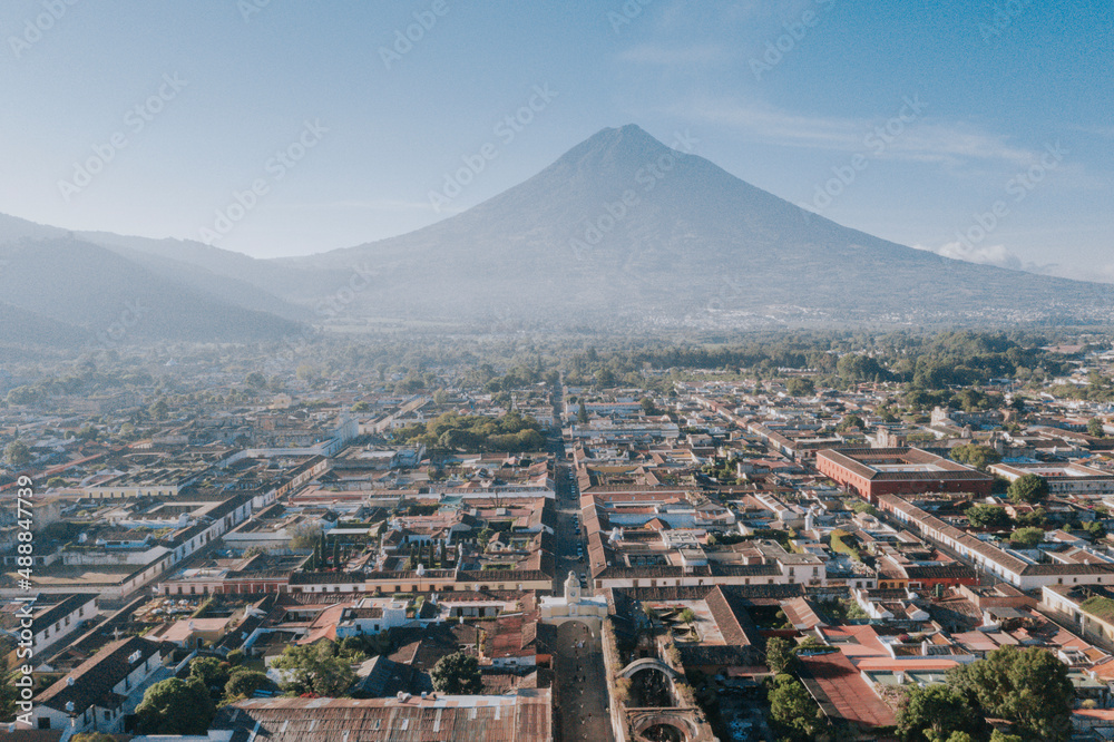 Antigua Guatemala, classic colonial city with the famous Santa Catalina Arch and Volcano of Water behind - Antigua Guatemala aerial photography