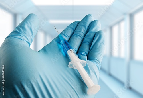 A vaccine  doctor or nurse hands taking covid vaccination booster shot